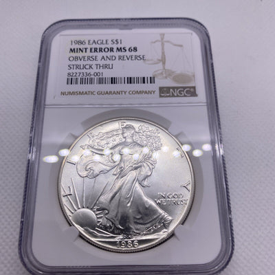 1986 $1 AMERICAN SILVER EAGLE NGC MS68 OBVERSE & REVERSE STRUCK THRU MINT ERROR