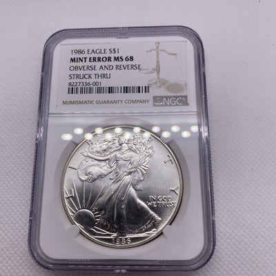 1986 $1 AMERICAN SILVER EAGLE NGC MS68 OBVERSE & REVERSE STRUCK THRU MINT ERROR