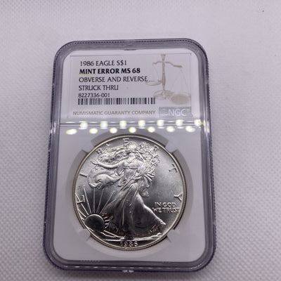 1986 $1 AMERICAN SILVER EAGLE NGC MS68 OBVERSE & REVERSE STRUCK THRU MINT ERROR